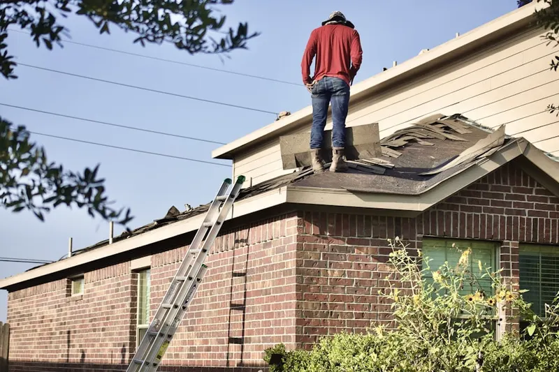 Professional roofer working on a residential roof in Greenwald